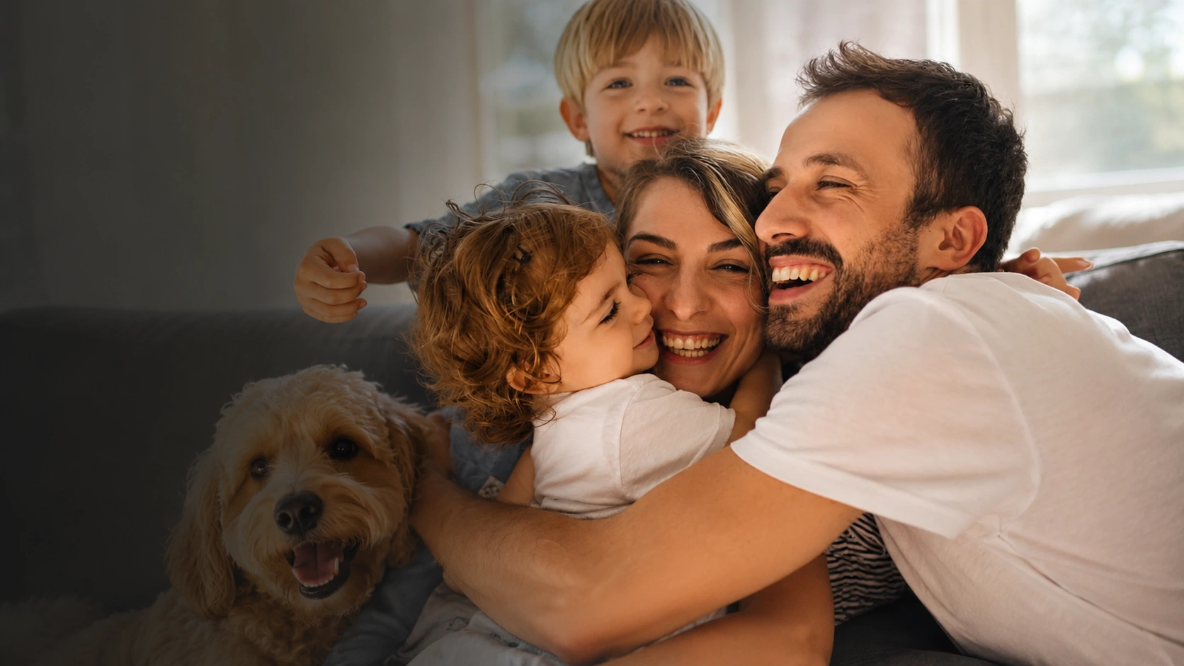 Happy family laughing together with their dog at home