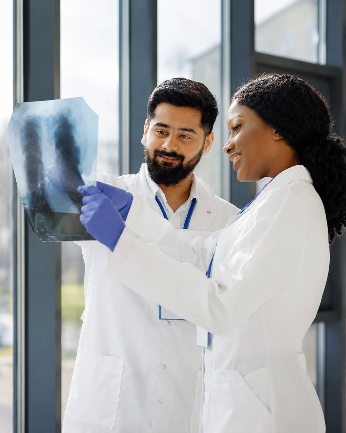 Two physicians collaborating while reviewing a chest X-ray